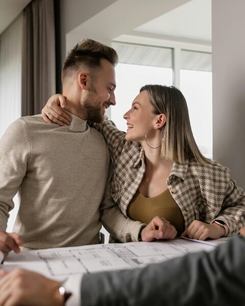 Couple reviewing home plans with advisor