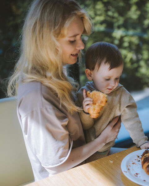 Parent and child enjoying breakfast outdoors